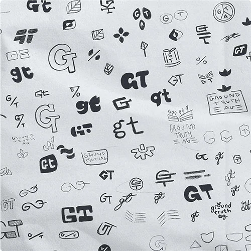 A sheet of hand-drawn logo sketches exploring letter mark concepts for 